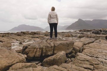 senior women standing on a rock